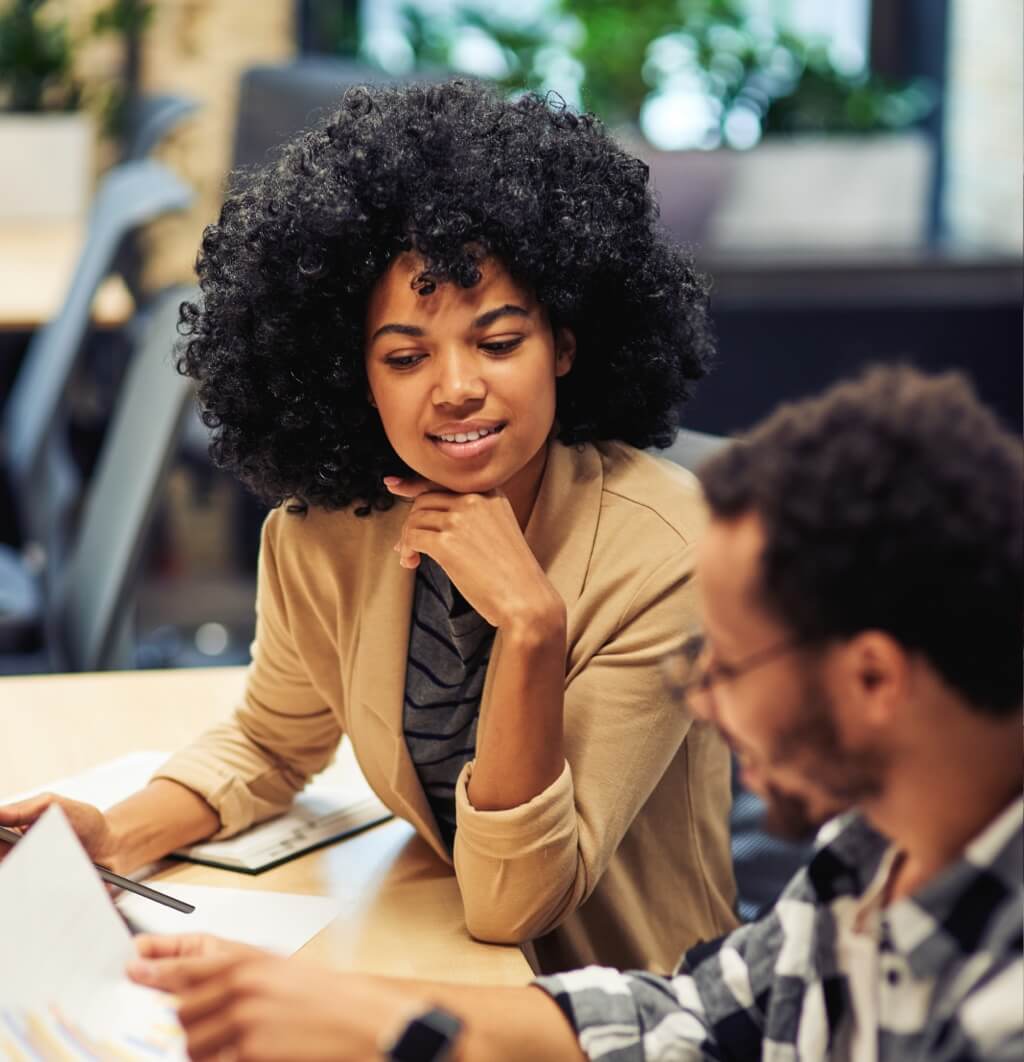 A male and female collegue collaborating at work