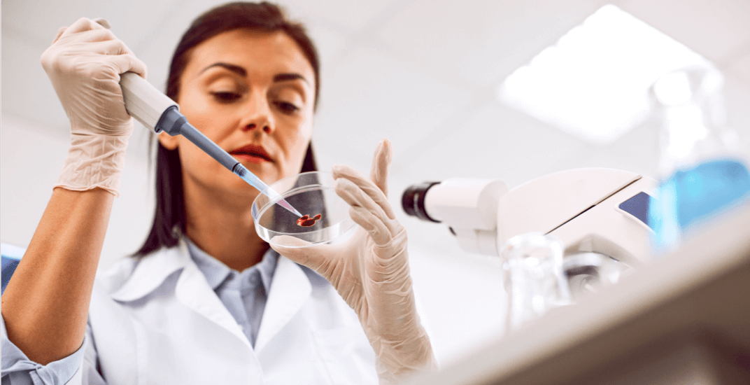 A female scientist conducting a blood test