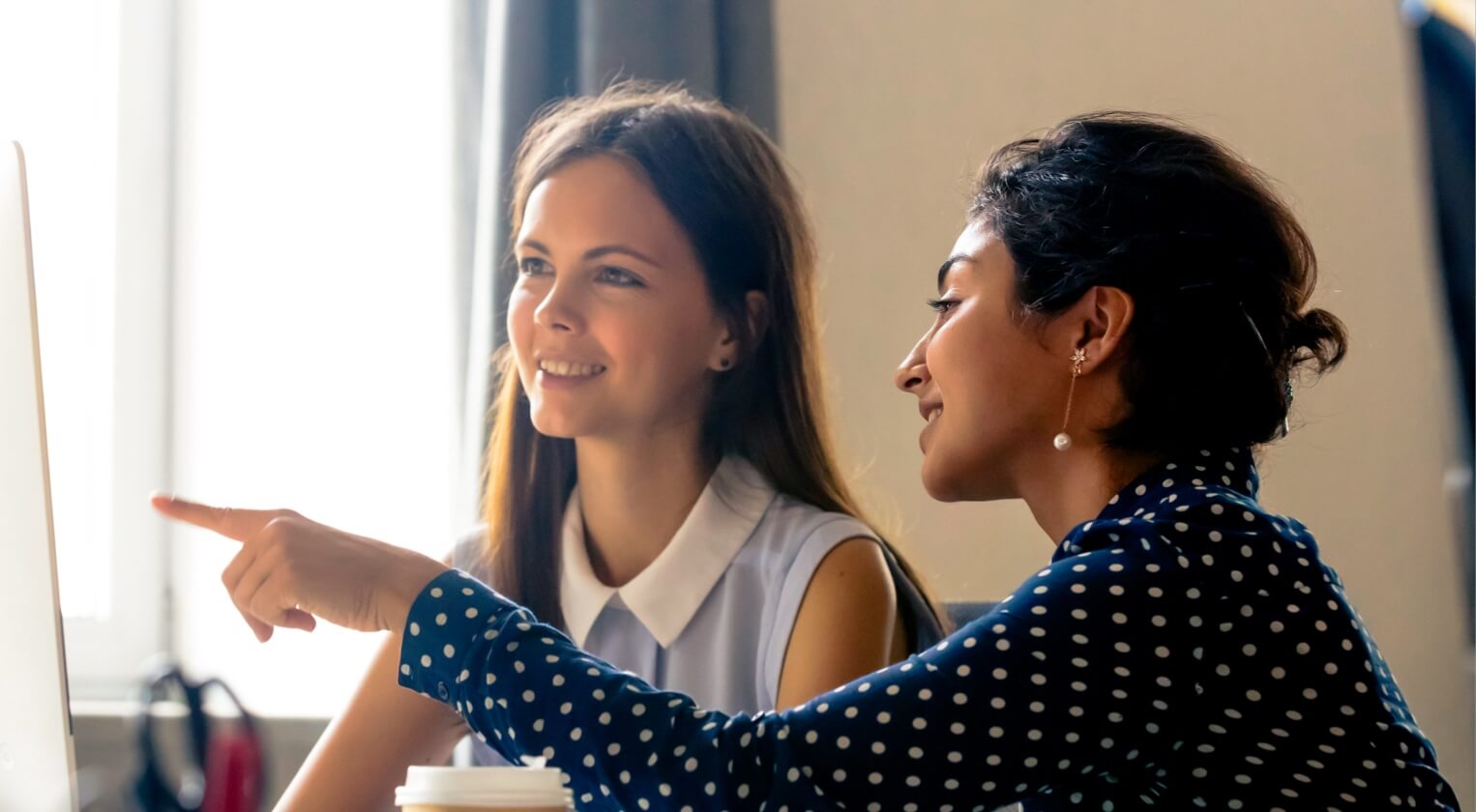 Two female Employee Experience experts discussing company culture