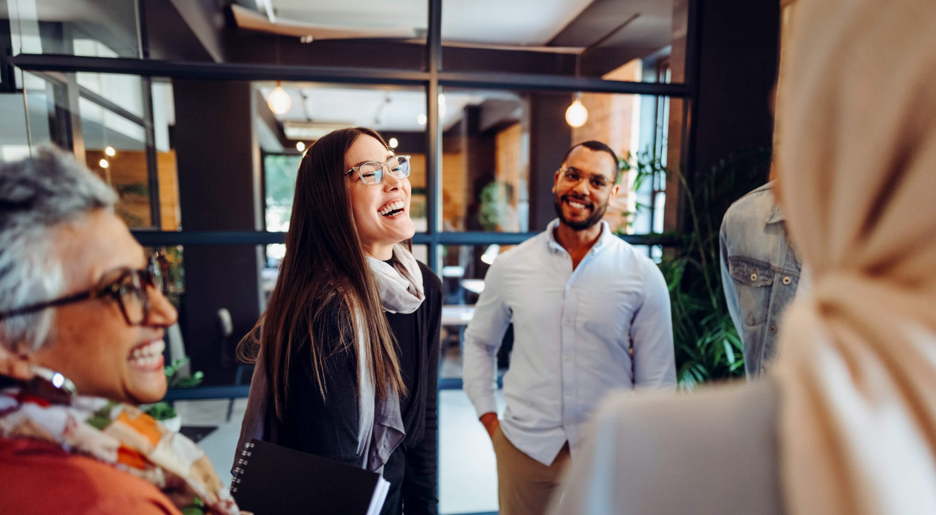  A group of people talking happily as they arrive at work