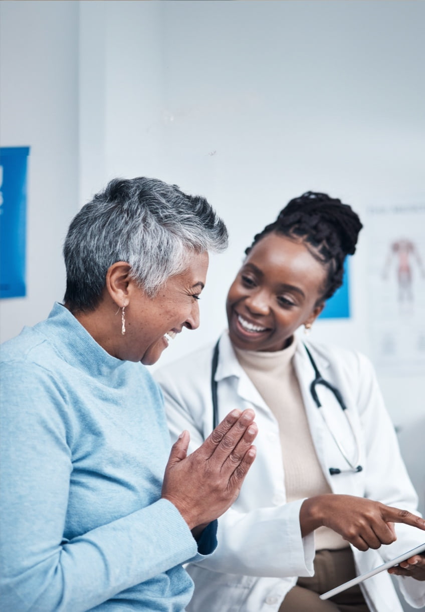 A healthcare professional discussing positive news with her patient